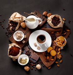 Coffee with snacks on black background.