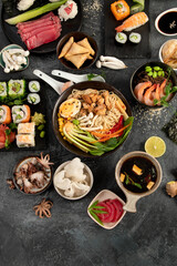 Japanese dishes and snacks on gray background.