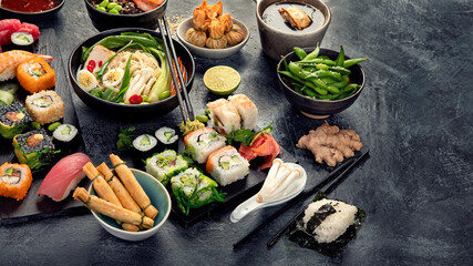 Japanese dishes and snacks on gray background.