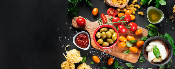 Fototapeta na wymiar Italian food and snacks on dark background.