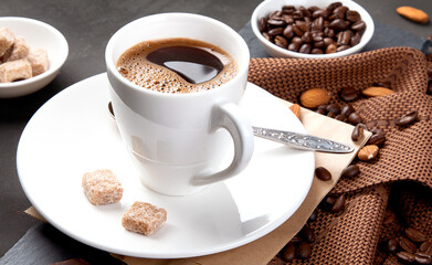 Coffee with snacks on black background.