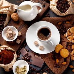 Coffee with snacks on black background.