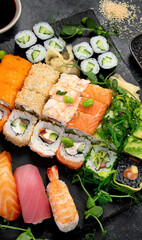 Sushi and roll set on dark background. Traditional food concept.