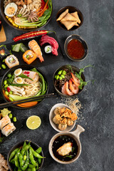 Japanese dishes and snacks on gray background.