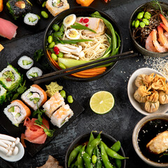 Japanese dishes and snacks on gray background.