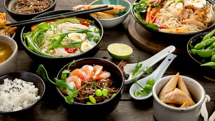 Asian dishes and snacks on wooden background.