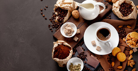 Coffee with snacks on black background.