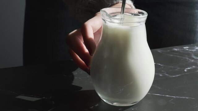 Beat the milk in a mug using a frother. Hand mixer for milk. Making foamy with frother. Preparing milk for coffee. Step by step. Jug appliance starting up and turning around to froth white causing bub