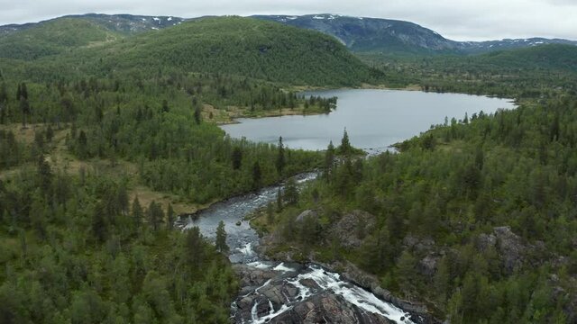 Aerial view over the Edlandsfossen waterfall, in Agder, Norway - tilt, drone shot
