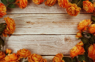Top view Blooming Flowers frame with copy space on wooden background