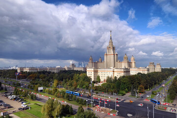 Aerial panoramic view of campus buildings of famous Moscow university under dramatic cloudy sky in early autumn
