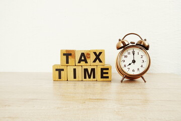 Tax Time with alarm clock with space copy on wooden background