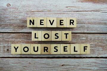 Never Lost Yourself word alphabet letters on wooden background