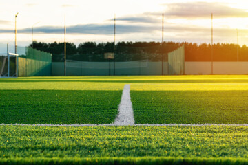 Obraz premium A white line on a football field covered with synthetic plastic lawn