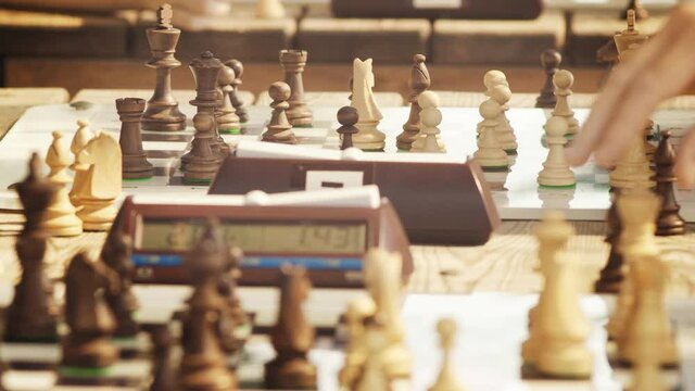 Close-up chess game, make moves and press the chess timer button, blur