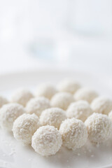 Coconut cakes light dessert in the form of balls on a light background