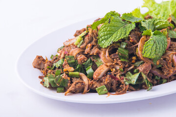 Spicy minced pork salad on the white dish.