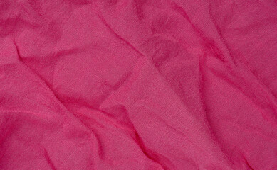 Fototapeta premium wrinkled pink fabric texture background closeup