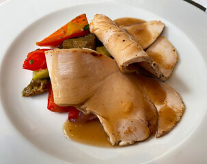 Slices of roasted veal with vegetables. Italian Cuisine