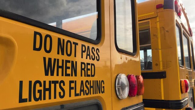Do Not Pass When Red Lights Flashing caution warning on back of school bus; 4K
