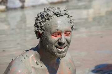 Portrait happy man who takes a mud bath. Dalyan, Turkey