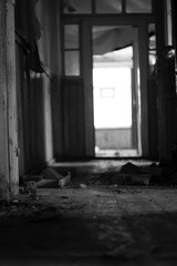 corridor of old abandoned wooden rural hospital in black and white