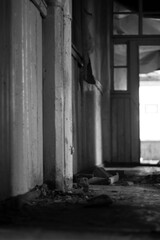 Fototapeta na wymiar corridor of old abandoned wooden rural hospital in black and white