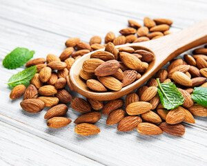 Almonds in brown spoon