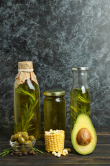 Set of different oils on rustic wooden table