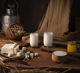 vintage still life with organic and raw milk, paneer, ghee, and curd