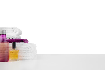 White towels and spa skincare cosmetics on white background