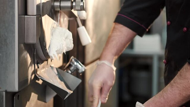 Male confectioner making ice cream at manufacture