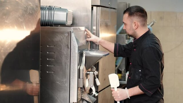 Male confectioner making ice cream at manufacture