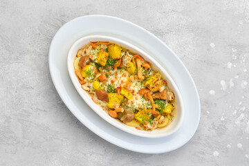 Top view of casserole with honey agarics, pumpkin and potatoes