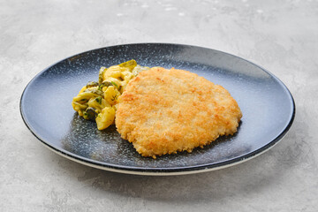 Pork schnitzel with potato and pickled cucumber
