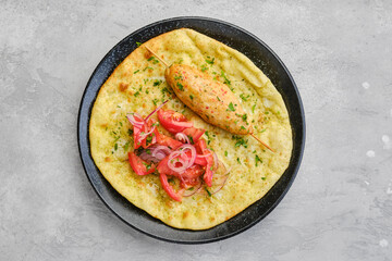 Top view of kebab served on tortilla with tomato and onion