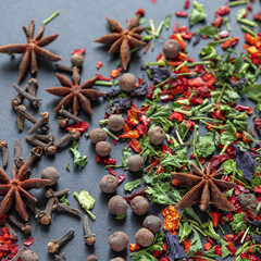 Different aromatic spices on dark background, close-up