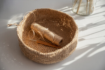 Jute needlework crochet baskets for decor on a white background and the suns rays.