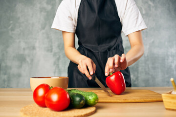 Woman in black apron lunch at home vegetarian food salad diet