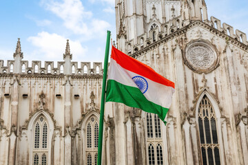 Fototapeta premium Indian national flag in front of St. Paul's Cathedral church Kolkata on Independence day 