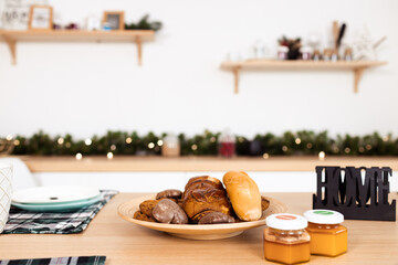 Kitchen table with cookies on plate and honey jars