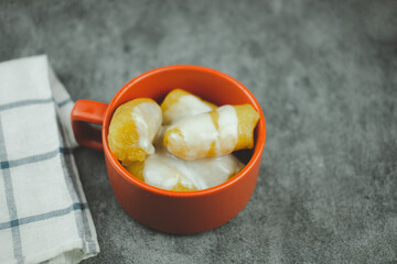 Sweet egg-banana in syrup topped coconut milk