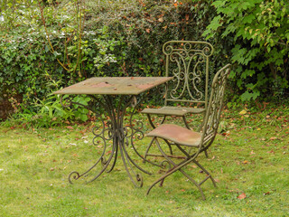 old rusted table and chairs in garden