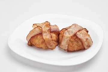 Cutlet on a white plate on a white background