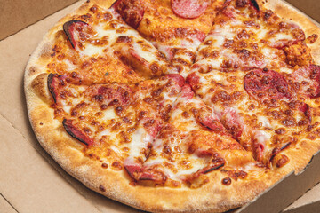 Top view of hot pizza in recycled pizza box.