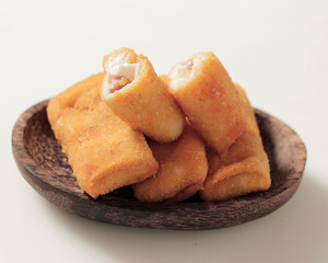 Fried spring rolls isolated on a bright background. This typical Semarang food, sometimes spelled lun pia, is a kind of traditional Chinese-Javanese snacks. Blurred focus. Snack food mockup