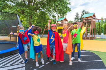 Group of young schooler wearing superhero costumes
