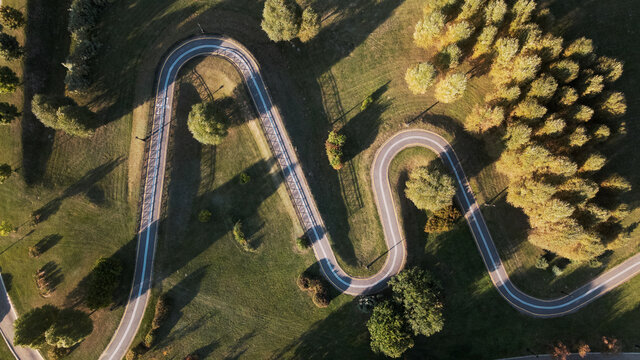 A winding bike path in a city park. Aerial photography at sunset.