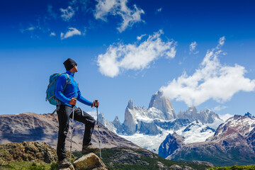 Active man hiking in the mountains. Patagonia, Mount Fitz Roy. Mountaineering sport lifestyle concept - obrazy, fototapety, plakaty