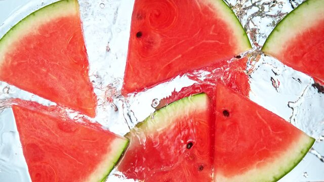 Super Slow Motion Shot of Splashing Fresh Melon Cuts into Water at 1000 fps.